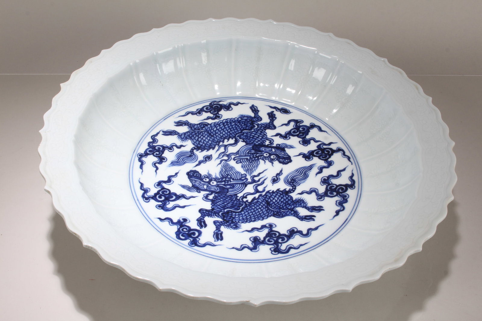 A Chinese Dragon-decorating Cutting-edge Blue and White Porcelain Fortune Plate: A Chinese Dragon-decorating Cutting-edge Blue and White Porcelain Fortune Plate. Height: 3.25 (inch). Opening Diameter: 17 (inch).