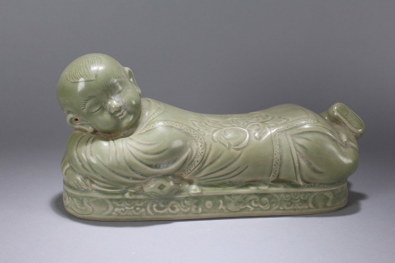 A Chinese Joyful-kid Porcelain Fortune Pillow-stand: A Chinese Joyful-kid Porcelain Fortune Pillow-stand. Height: 6.5 (inch). Width: 13 (inch). Length: 4 (inch).