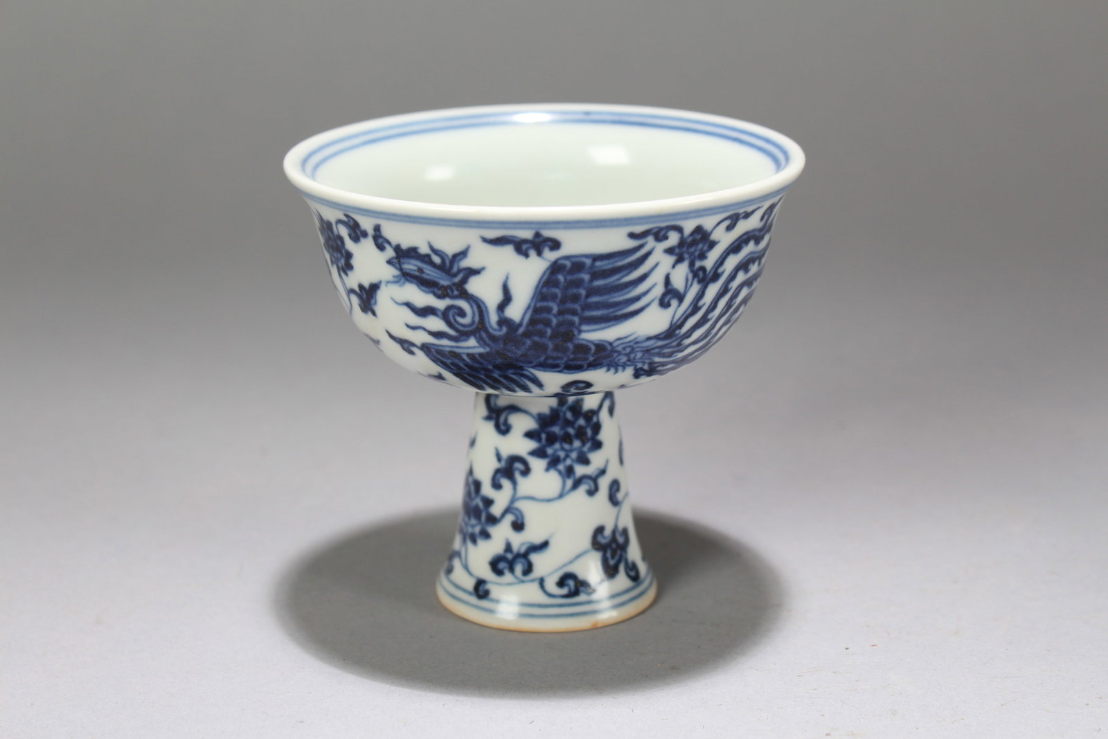 A Chinese Blue and White Phoenix-decorating Porcelain Cup: A Chinese Blue and White Phoenix-decorating Porcelain Cup. Height: 3.25 (inch). Width: 3.5 (inch).