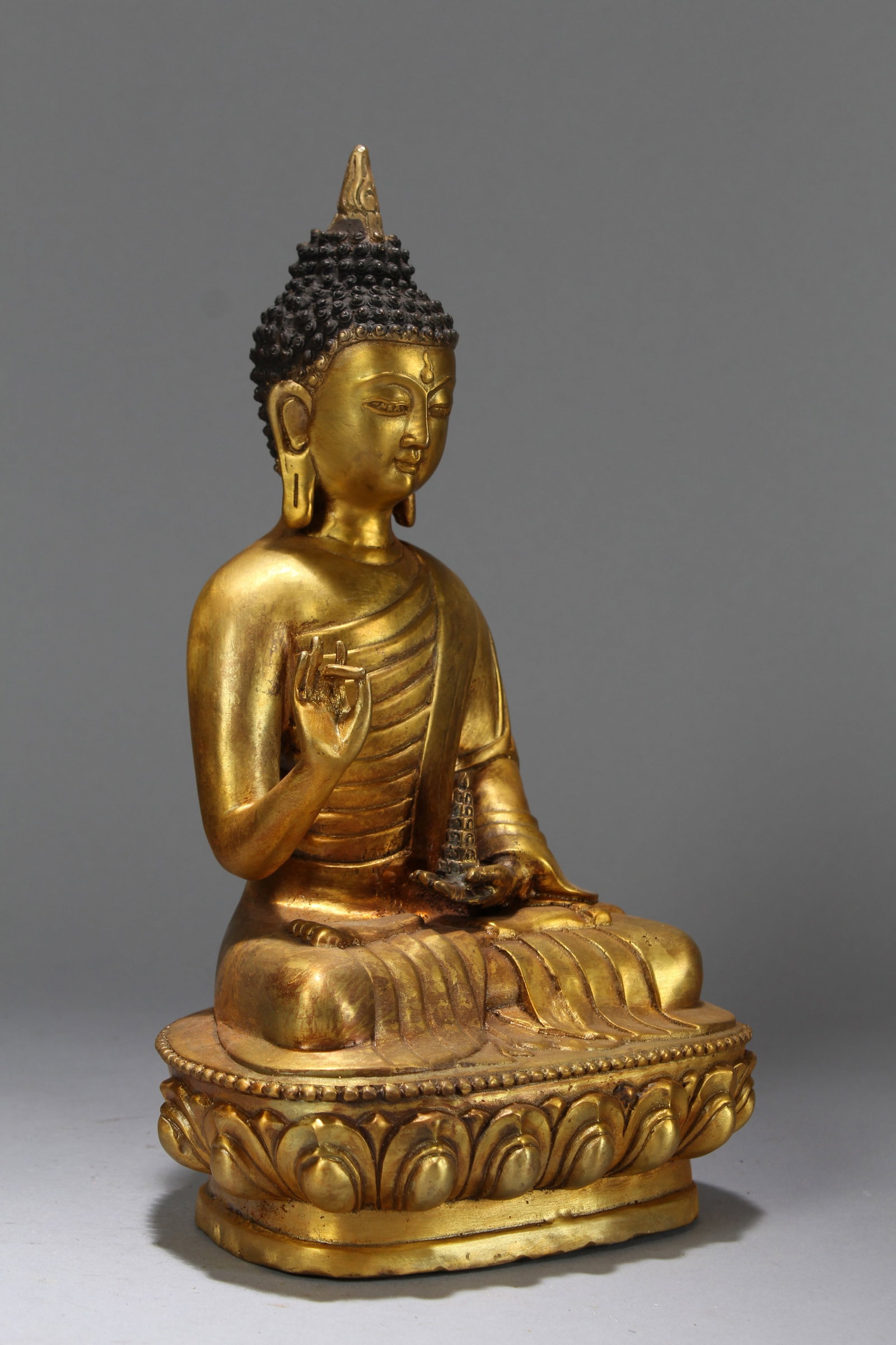 A Chinese Vividly-detailed Religious Lotus-framing Gilt Fortune Buddha Statue: A Chinese Vividly-detailed Religious Lotus-framing Gilt Fortune Buddha Statue. Height: 11.75 (inch). Length: 6.75 (inch). Width: 4.75 (inch).