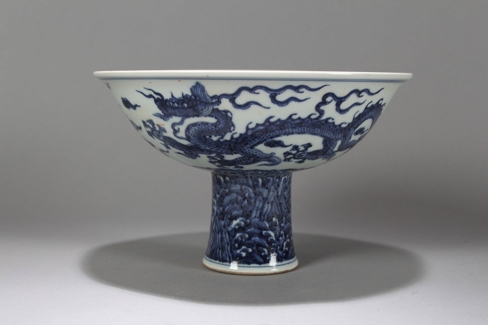 A Chinese Dragon-decorating Blue and White Tall-end Porcelain Cup: A Chinese Dragon-decorating Blue and White Tall-end Porcelain Cup. Height: 6 (inch). Opening Diameter: 9.75 (inch).