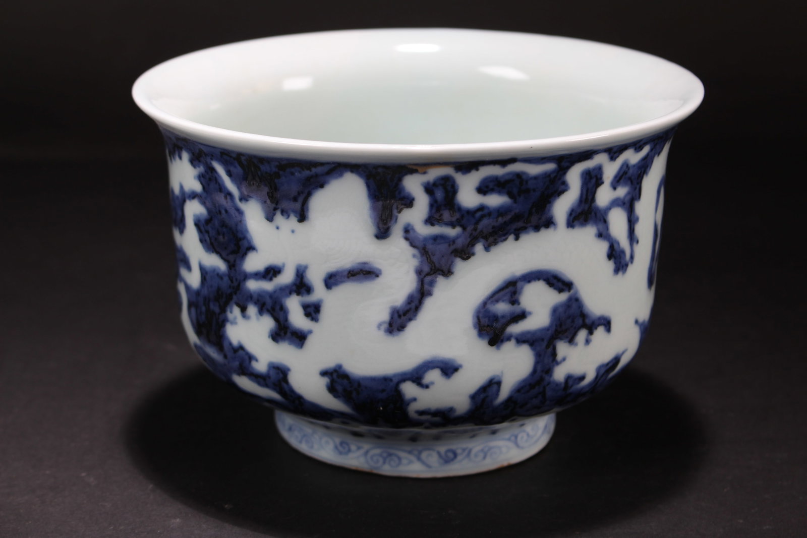 A Chinese Blue and White Dragon-decorating Porcelain Fortune Cup: A Chinese Blue and White Dragon-decorating Porcelain Fortune Cup. Height: 4 (inch). Opening Diameter: 6.25 (inch).