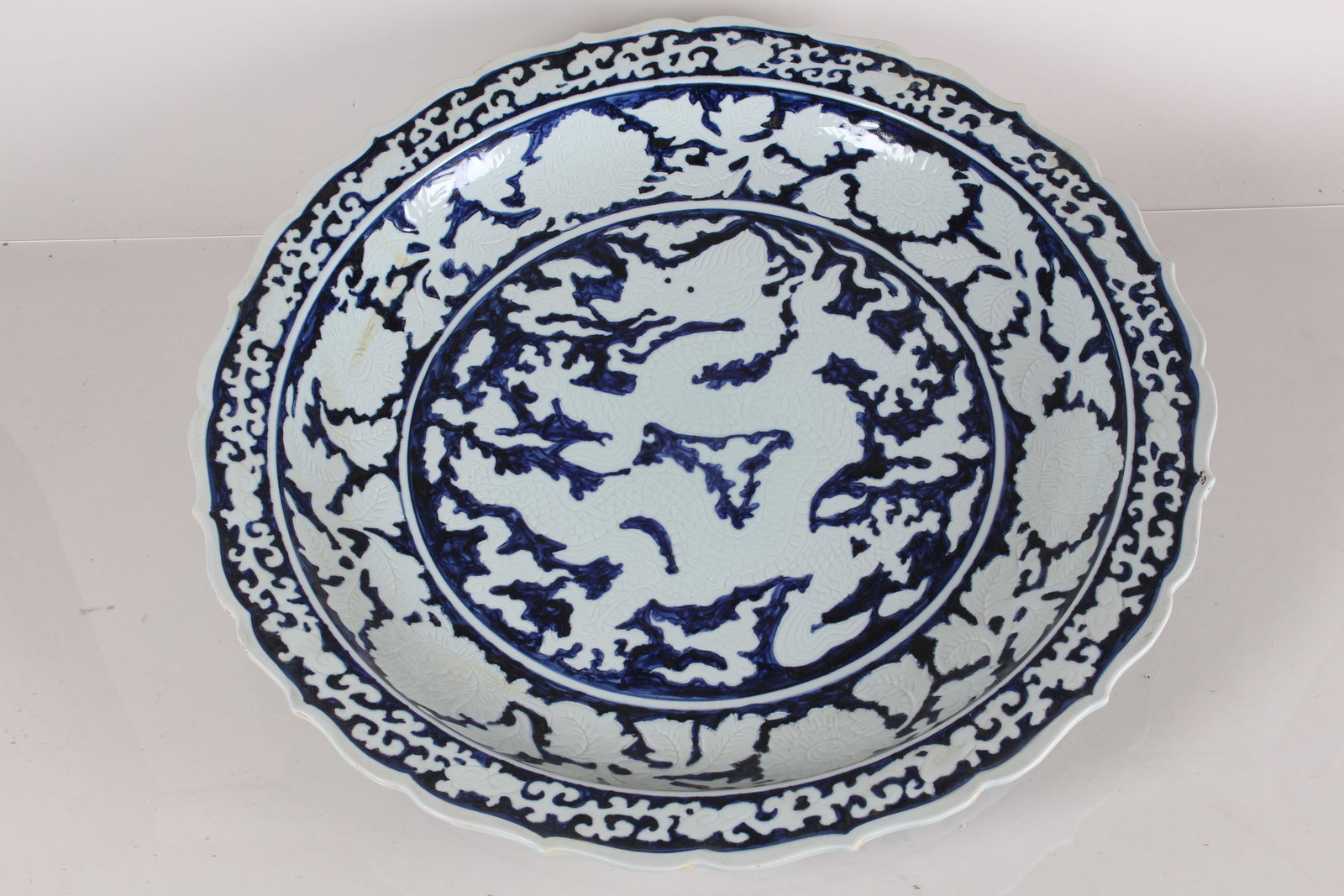 A Chinese Blue and White Massive Dragon-decorating Porcelain Fortune Plate: A Chinese Blue and White Massive Dragon-decorating Porcelain Fortune Plate. Height: 2.75 (inch). Opening Diameter: 22.75 (inch).