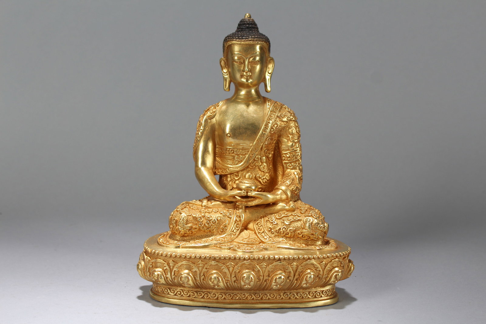 A Chinese Vividly-detailed Lotus-framing Gilt Fortune Buddha Statue: A Chinese Vividly-detailed Lotus-framing Gilt Fortune Buddha Statue. Height: 8.75 (inch). Length: 7.5 (inch). Width: 3.5 (inch).