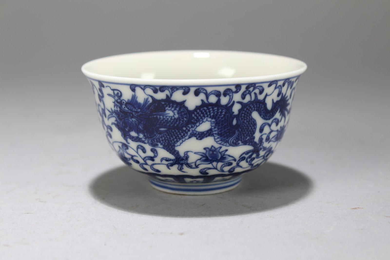 A Chinese Blue-and-white Fortune Dragon-decorating Porcelain Cup: A Chinese Blue-and-white Fortune Dragon-decorating Porcelain Cup. Height: 1.75 (inch). Opening Diameter: 3.25 (inch)