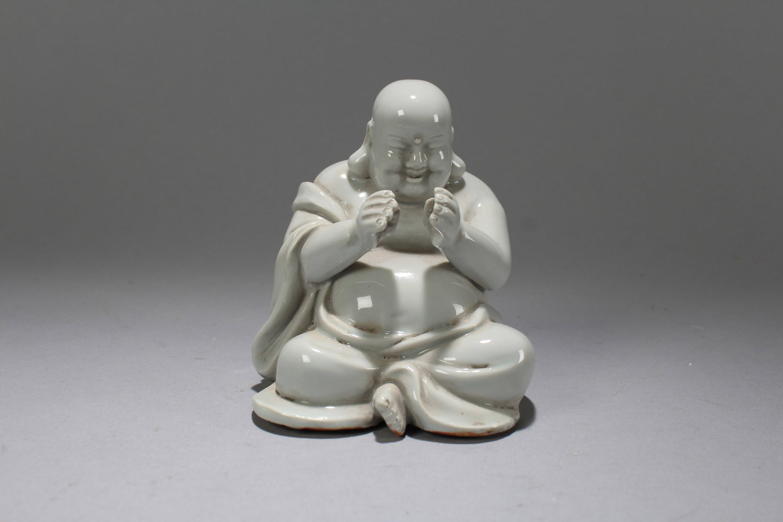 A Chinese De Blac Happy-buddha Porcelain Fortune Statue: A Chinese De Blac Happy-buddha Porcelain Fortune Statue. Height: 4.5 (inch). Width: 3.5 (inch). Length: 4 (inch)