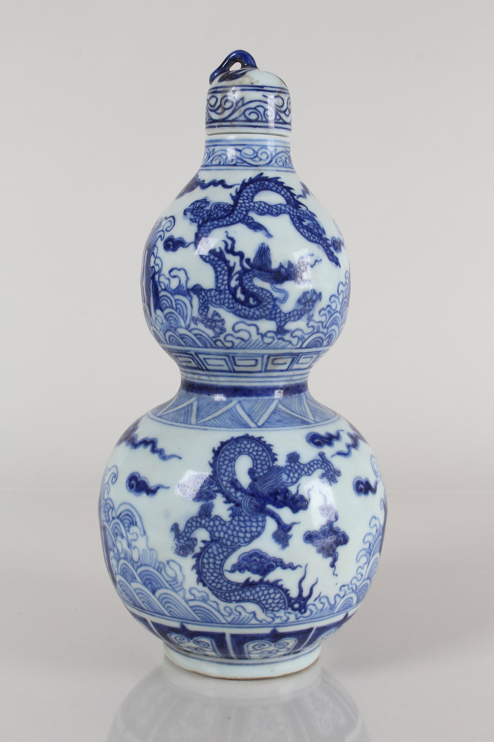 A Chinese Lidded Blue and White Detailed Dragon-decorating Porcelain Vase: A Chinese Lidded Blue and White Detailed Dragon-decorating Porcelain Vase . Height: 10.25 (inch).
