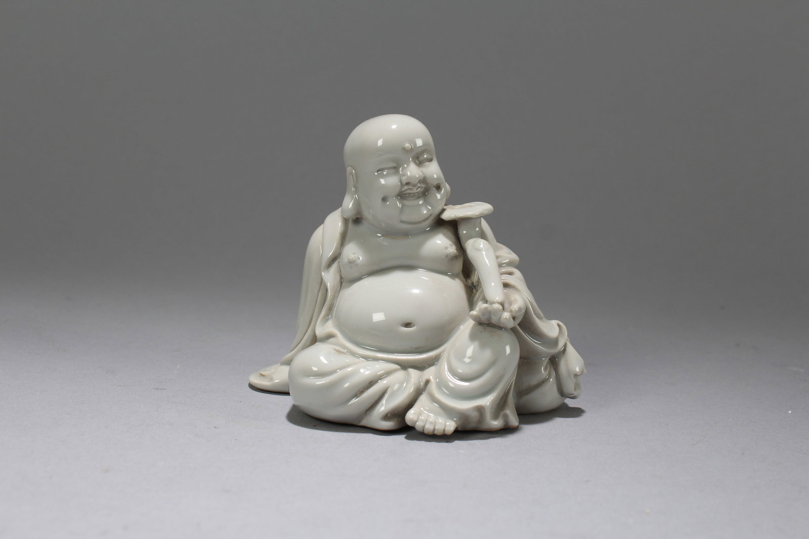A Chinese De Blac Happy-buddha Porcelain Fortune Statue: A Chinese De Blac Happy-buddha Porcelain Fortune Statue. Height: 3.25 (inch). Width: 4 (inch). Length: 2.5 (inch)