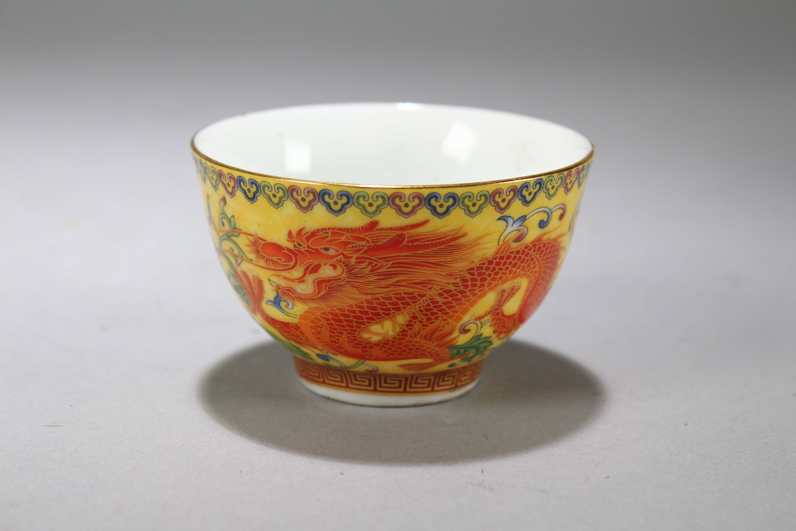 A Chinese Bat-framing Dragon-decorating Porcelain Fortune Cup: A Chinese Bat-framing Dragon-decorating Porcelain Fortune Cup. Height: 2 (inch). Opening Diameter: 3 (inch)