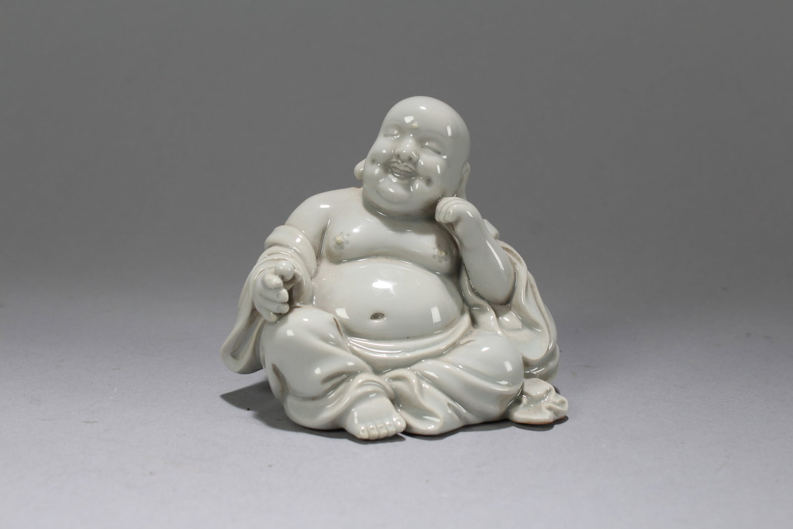 A Chinese De Blac Happy-buddha Porcelain Fortune Statue: A Chinese De Blac Happy-buddha Porcelain Fortune Statue. Height: 4 (inch). Width: 3.5 (inch). Length: 3.25 (inch)