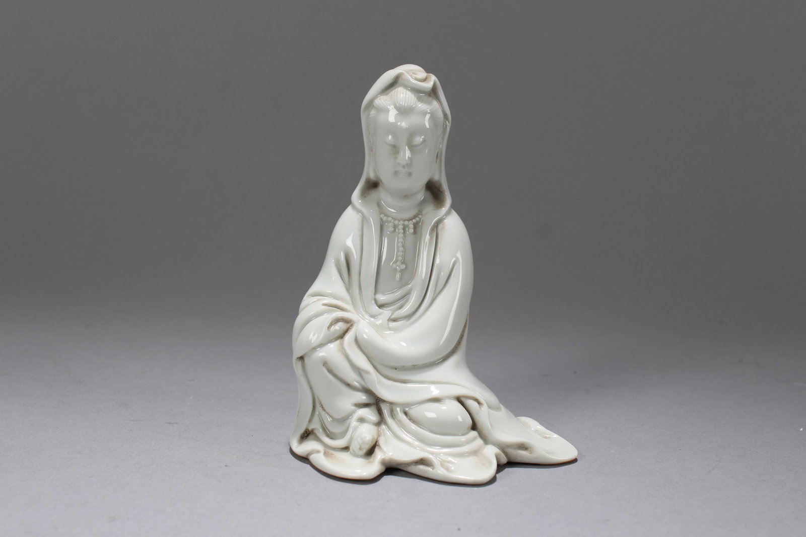 A Chinese De Blac Porcelain Fortune Guanyin Fortune Statue: A Chinese De Blac Porcelain Fortune Guanyin Fortune Statue. Height: 4.25 (inch). Width: 3.25 (inch). Length: 2.5 (inch)
