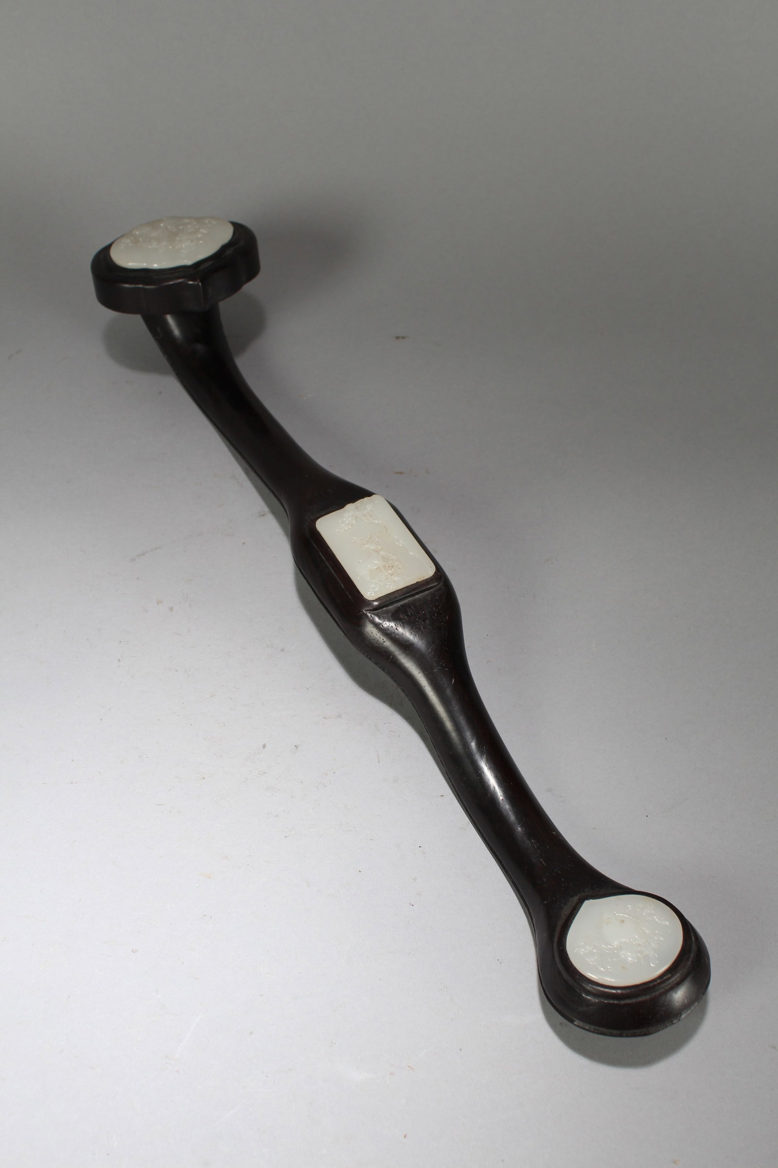 A Chinese Jade-inserted Fortune Wooden Ruyi: A Chinese Jade-inserted Fortune Wooden Ruyi. Height: 2.75 (inch). Length: 20 (inch) Width: 3.25 (inc).