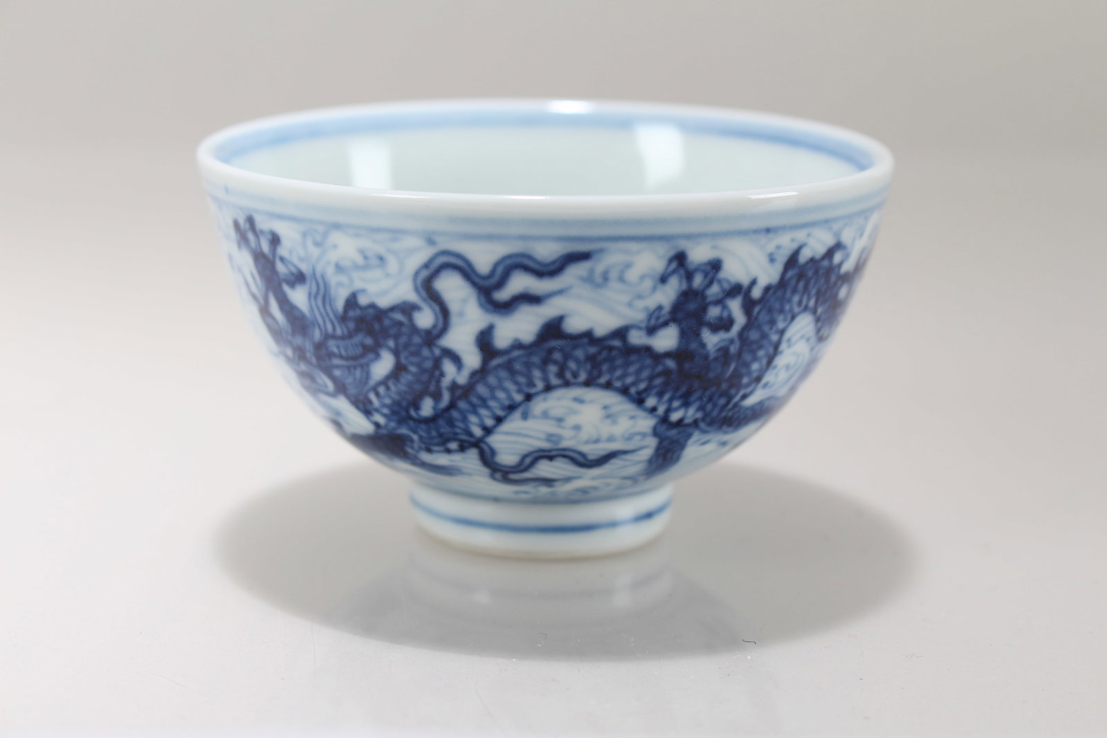 A Chinese Blue and White Dragon-decorating Porcelain Cup: A Chinese Blue and White Dragon-decorating Porcelain Cup . Height: 1.75 (inch). Opening Diameter: 3.25 (inch)