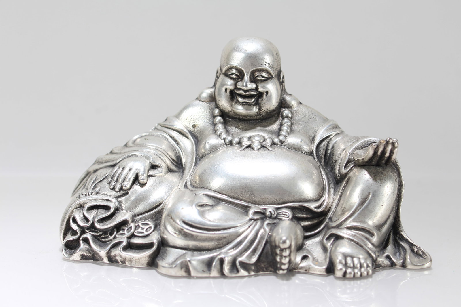 A Chinese Happy Buddha Statue: A Chinese Happy Buddha Statue. Height: 3.25 (inch). Length: 5.5 (inch). Width: 3 (inch).