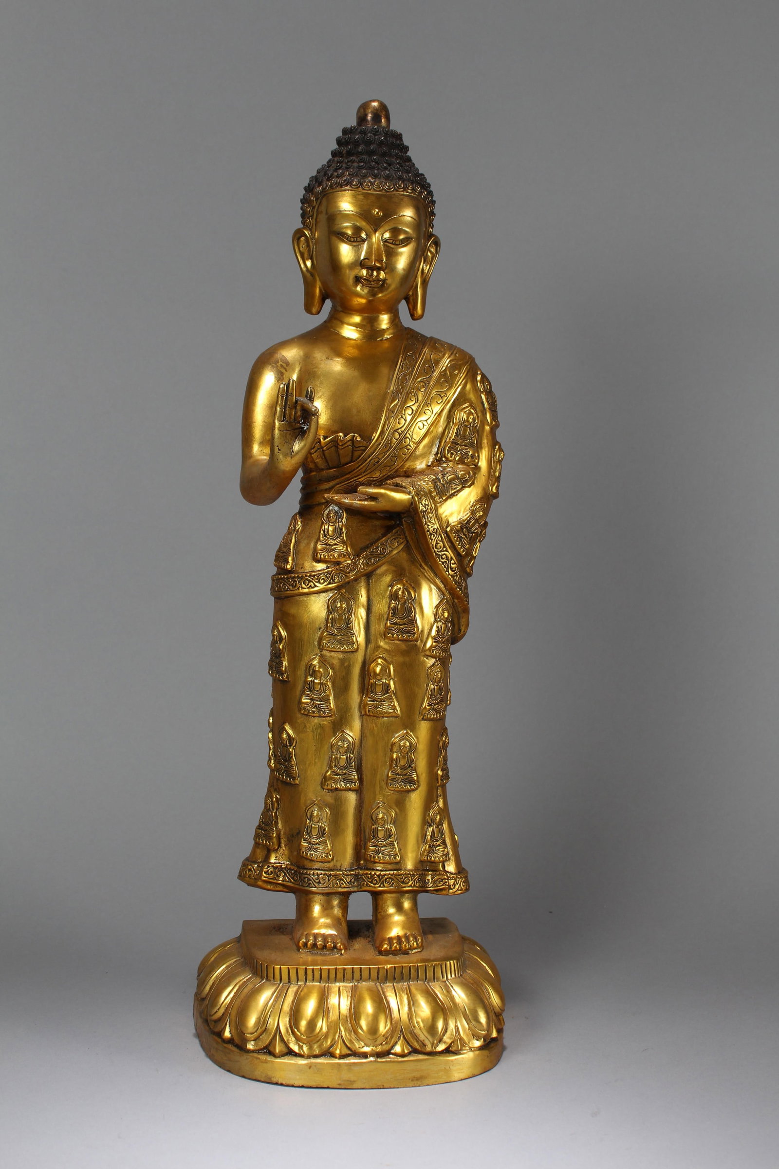 A Chinese Standing-still Pondering-pose Gilt Fortune Buddha Statue: A Chinese Lotus-seated Gilt Fortune Buddha Statue. Height: 21.75 (inch). Width: 7 (inch). Length: 5.5 (inch)