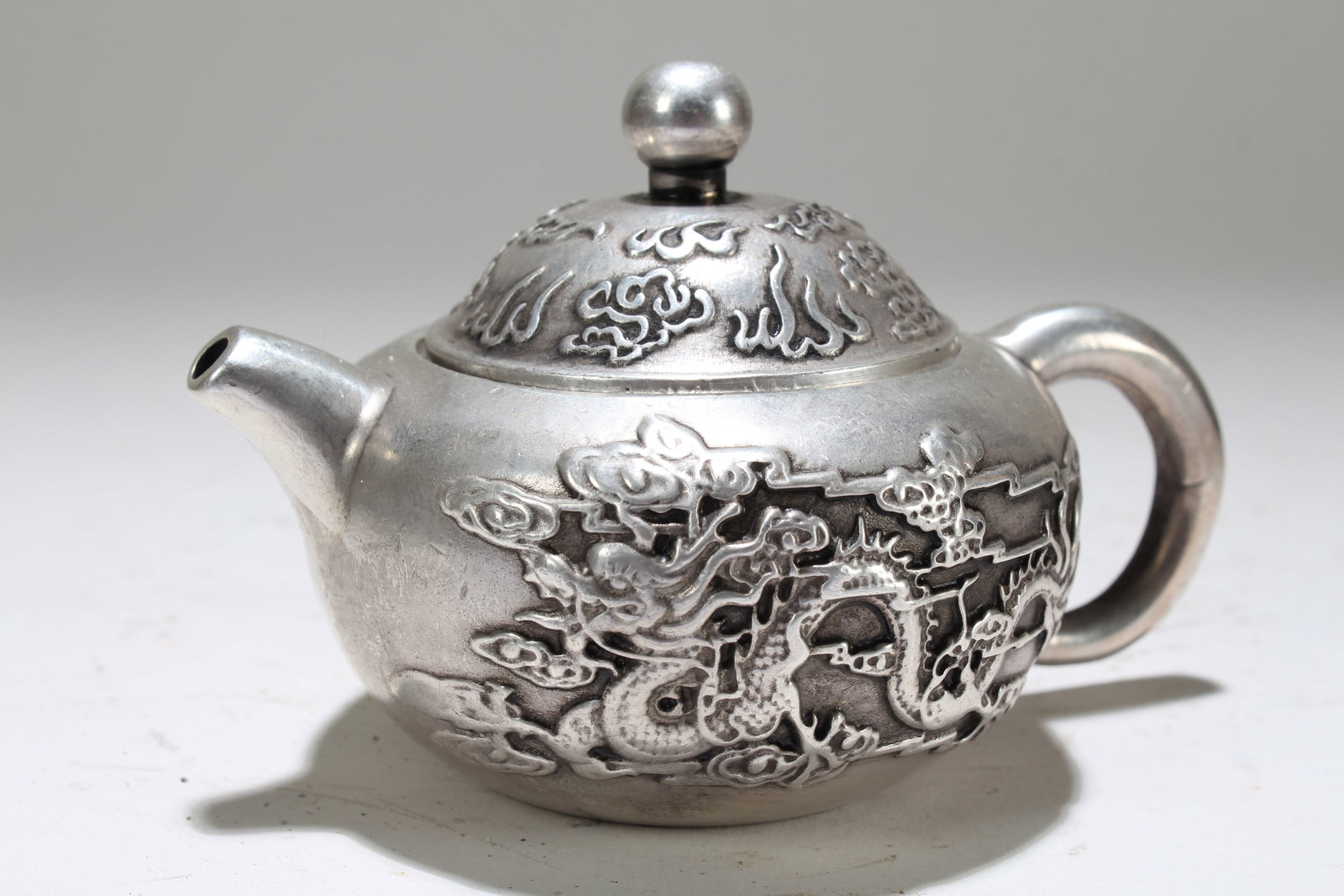 A Chinese Dragon-decorating Fortune Lidded Tea Pot: A Chinese Dragon-decorating Fortune Lidded Tea Pot. Height: 2.5 (inch). Length: 4 (inch).
