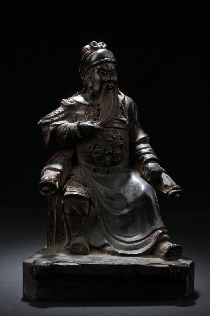 Chinese Bronze Figure: China, antique bronze figure of Guan Gong, carved emperor figure in long robes with a long beard seated on a decorative throne. Length 4 in., Height 15 in.