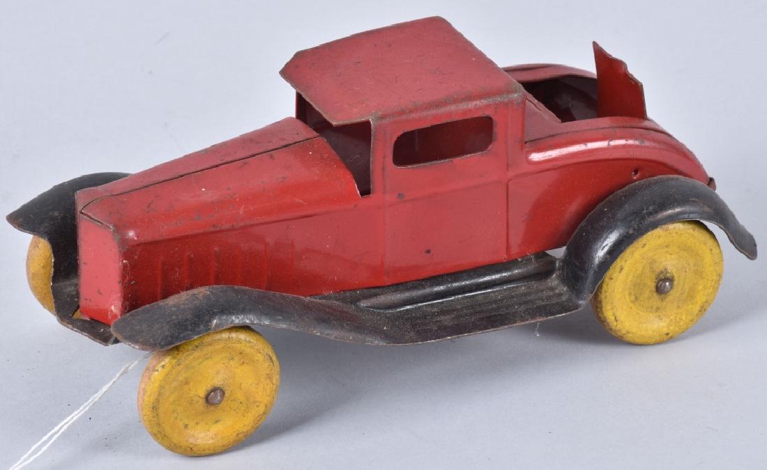 1930'S WYANDOTTE RUMBLE SEAT COUPE: 8" long, pressed steel with wood wheels, light wear. Should clean to a higher grade. Very Good