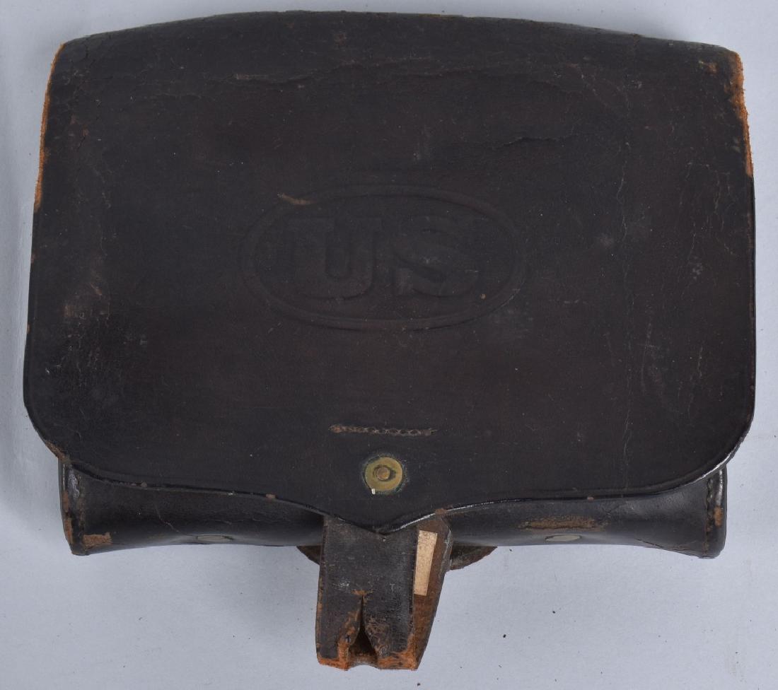 1870'S INDIAN WARS HAGNER TYPE 1 CARTRIDGE BOX: Designed in 1872 by Colonel Paul V. Hangner. Flap is embossed US, and holds 24 cartridges with a side pocket for a combination tool. Id'd with soldiers name inside flap, Light wear. Very Good