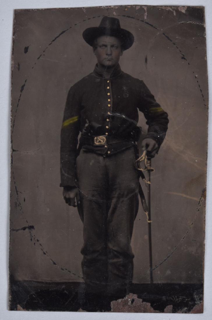 CIVIL WAR TINTYPE FEDERAL ARMED CAVALRYMAN: About 2 1/2" by 4" (cdv size), nice image of double armed cavalryman with m1860 Colt army and m1860 cavalry sword. Image is clear, and has some loss at the bottom. Very Good