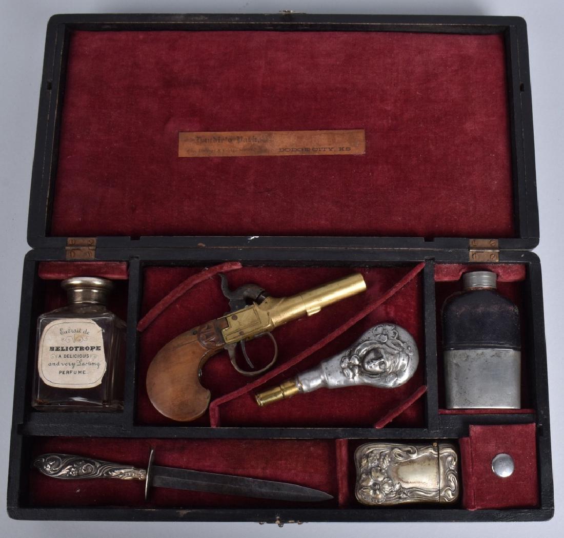 ALICE'S BOX, PISTOL and KNIFE SET, DODGE CITY: Set box measures 13" by 6 3/4". Very nice set includes original Belgian brass percussion pistol in working order, a silver handle dirk measuring 7 1/2", a powder flask, a silver match safe, a leather 