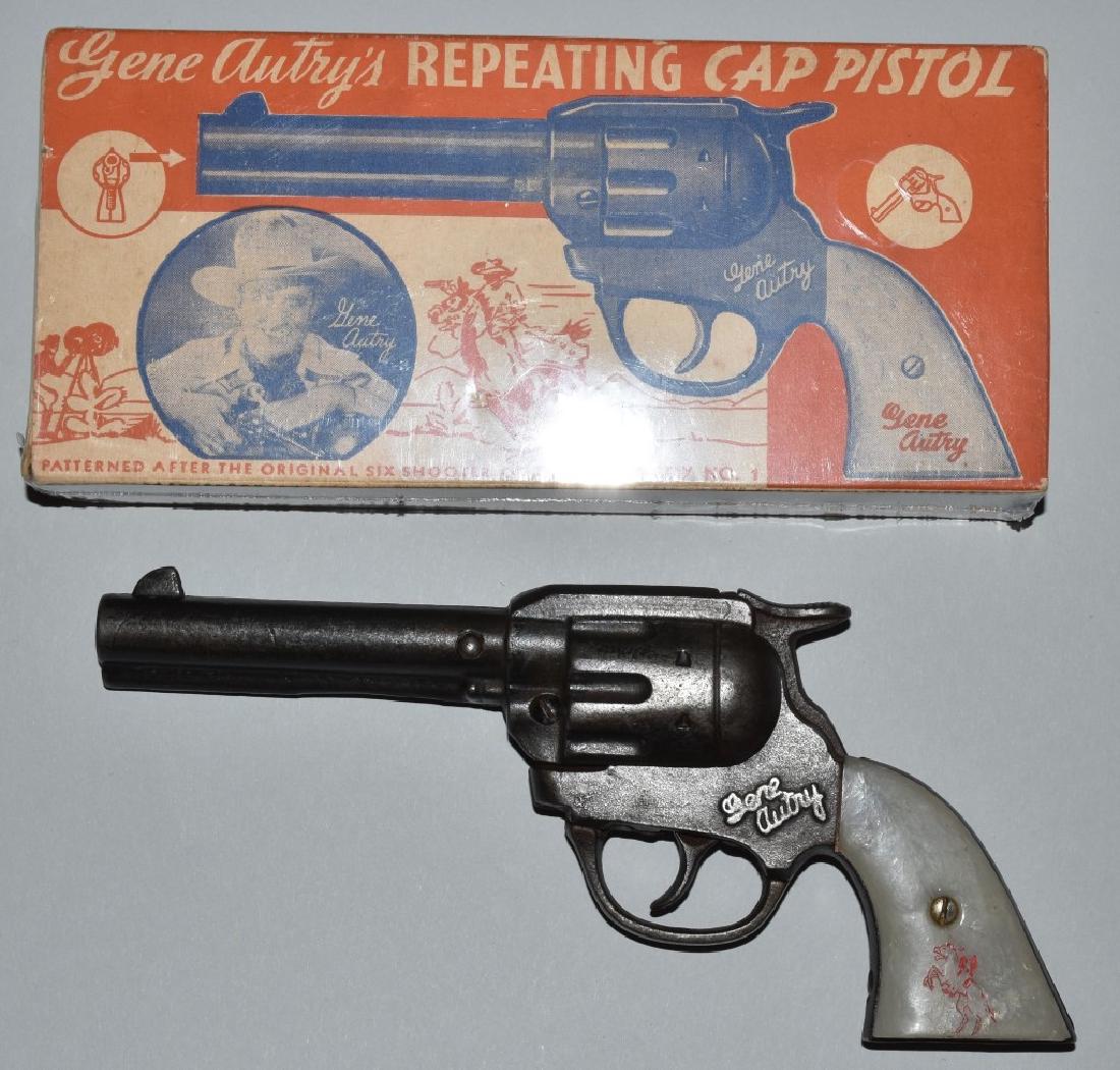 KENTON GENE AUTRY CAST IRON CAP PISTOL, BOXED: 8 1/2" worked when tested, general wear to finish. Nice colorful original box missing an end flap. Very Good-Excellent