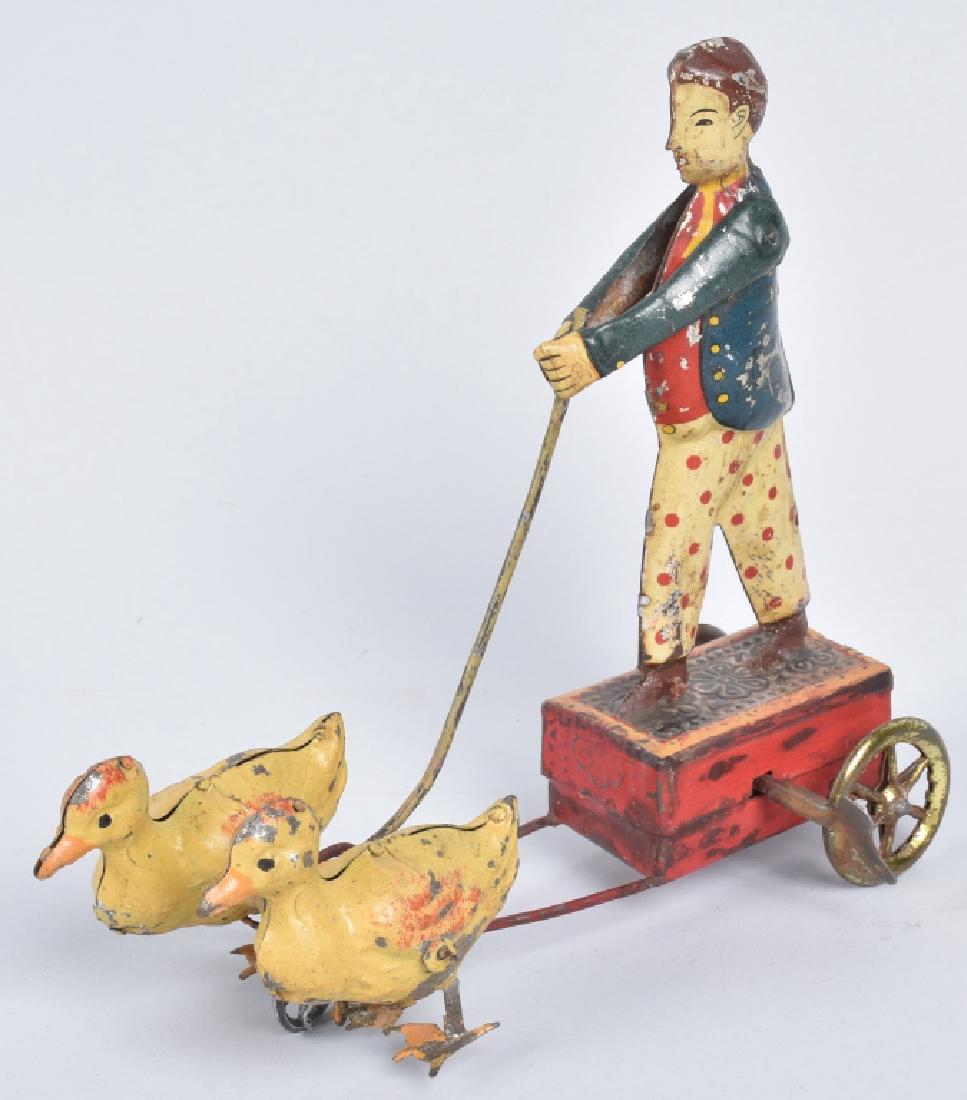TIN WINDUP MAN BEING PULLED BY DUCKS (1 of 4)