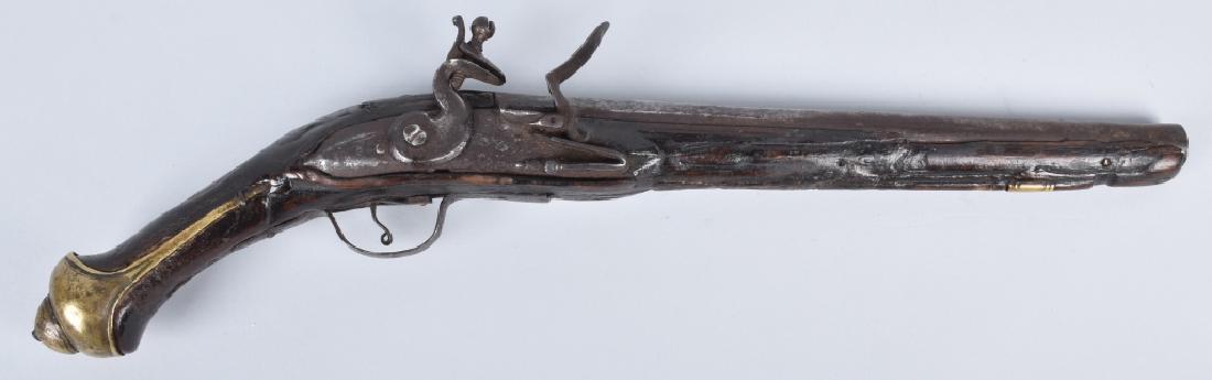 FLINTLOCK .69 MID EAST PISTOL: 11 1/2" engraved round barrel, carved stock with brass and iron furniture. Action works. Stock has chipping and cracks, iron is pitted. Good