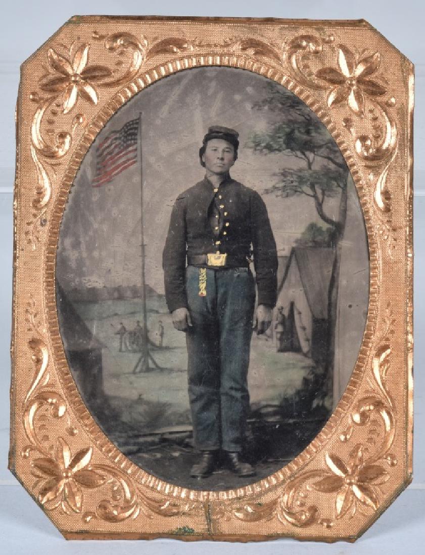 CIVIL WAR 1/4 PLATE FEDERAL SOLDIER TINTYPE: Civil War beautifully tinted quarter plate tintype of a cavalry soldier with rectangular belt plate. Backdrop including the American flag is artistically tinted as are the soldier's pants and watch fo