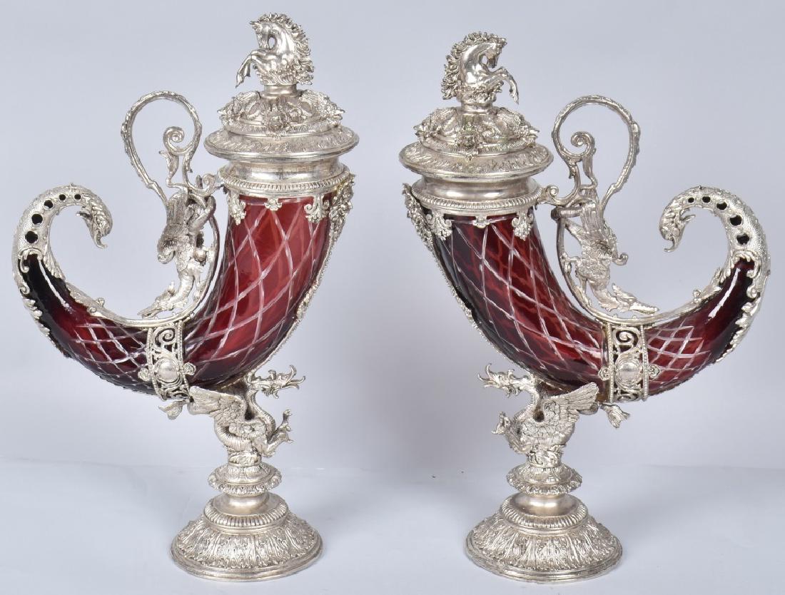 2- CUT CRANBERRY GLASS & SILVER HORN CHALICES: Beautiful pair Horn Chaises with cut cranberry colored glass with silver gilt work dragons. Very ornate. Both have tops with horses. Large and ornate pieces. No marking found. 20"