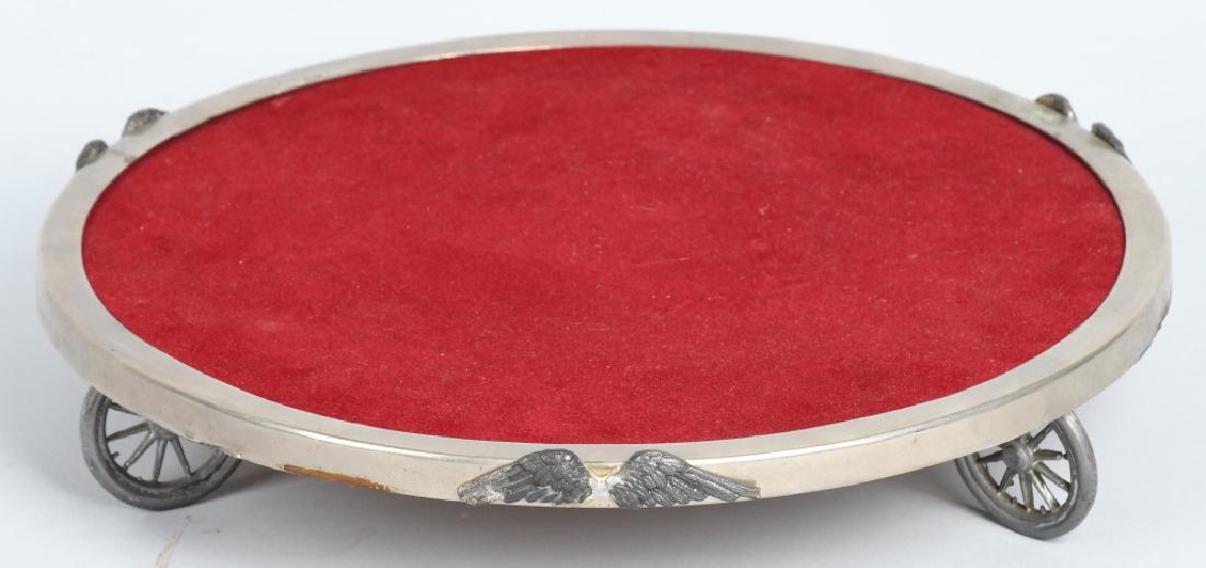 DISPLAY TRAY SET ON WHEELS WITH WINGS: Nice silver plate display tray setting on wheels with tires. Has wing decoration around the edges. Tray has red velvet top. 14"
