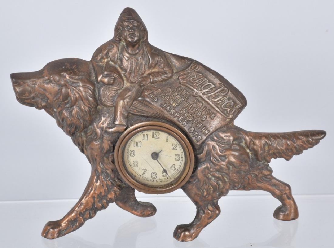 BERG BROS. ADVERTISING CAST IRON DOG CLOCK: Measures about 9" by 7", great copper flashed cast details of boy riding a setter dog, made by Golden Manufacturing Co. Chicago. Clock worked when tested. Excellent