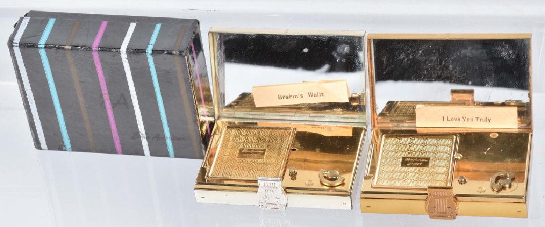 2-VINTAGE MUSICAL COMPACTS, 1 BOXED: Nice pair of compacts with windup music boxes. About 2 3/4" by 1 7/8". Both worked when they were tested, and one is in the original box. Excellent