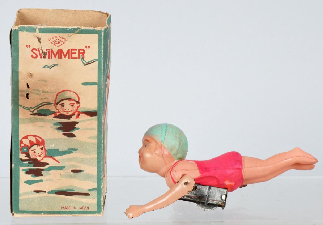 JAPAN 1930'S CELLULOID WINDUP SWIMMER, BOXED: 5 1/2'" very nice celluloid swimmer with windup action. Worked when tested. Includes graphic original box, missing top flap. Excellent May have some possible restoration.