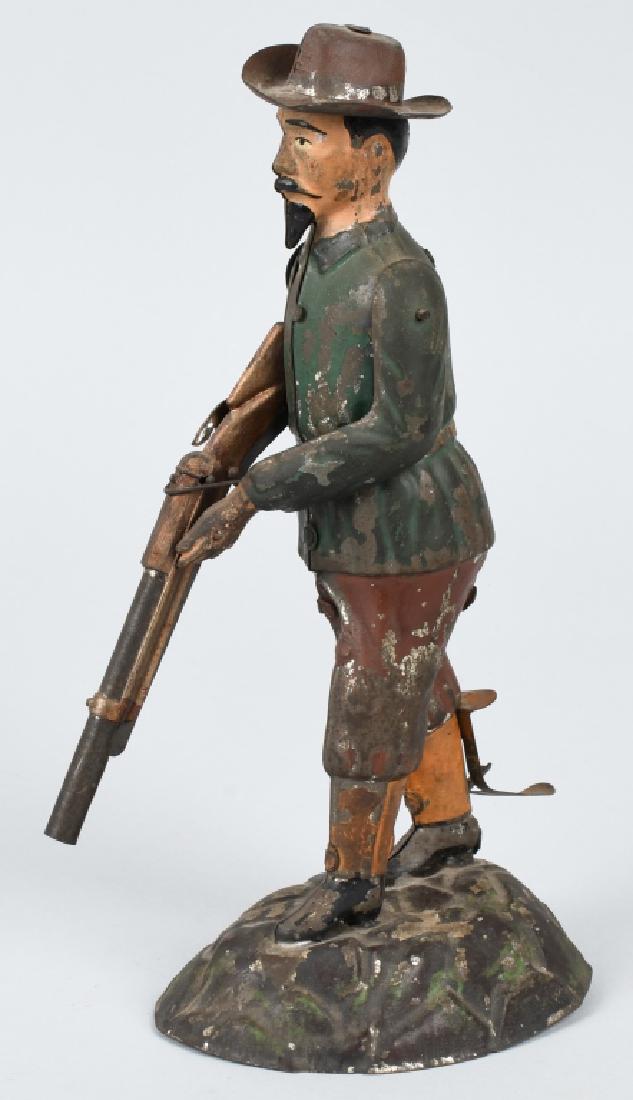 EARLY GERMAN GUNTHERMANN TIN BUFFALO BILL: Very nice hand painted tin likeness of Buffalo Bill, measuring 9 1/4" high. He raises his gun when the lever on his leg is pushed. Has paint loss, but displays great. Very Good