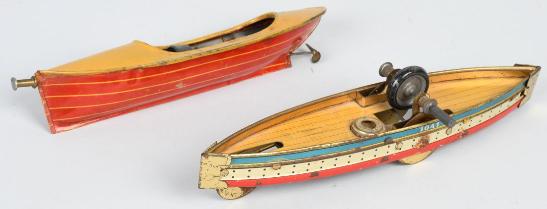 2-EARLY TIN FLY WHEEL BOATS, ONE CARRETTE: Largest is the boat attributed to Carrette at 9 1/4\". It was made for the American market and is red, white, and blue. The other boat is 8\" and is made by Reeves Mfg.Co. USA. Both are in nice condit
