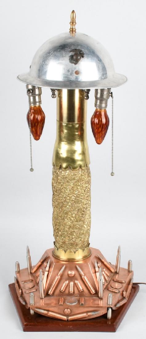 WWI TRENCH ART LAMP - WORKING CONDITION: 30" Trench art lamp made circa 1930s with modern rewiring. The base is decorated with bullets, buttons, French & Portuguese coins. A 22" artillery shell serves as the center post and features incredib