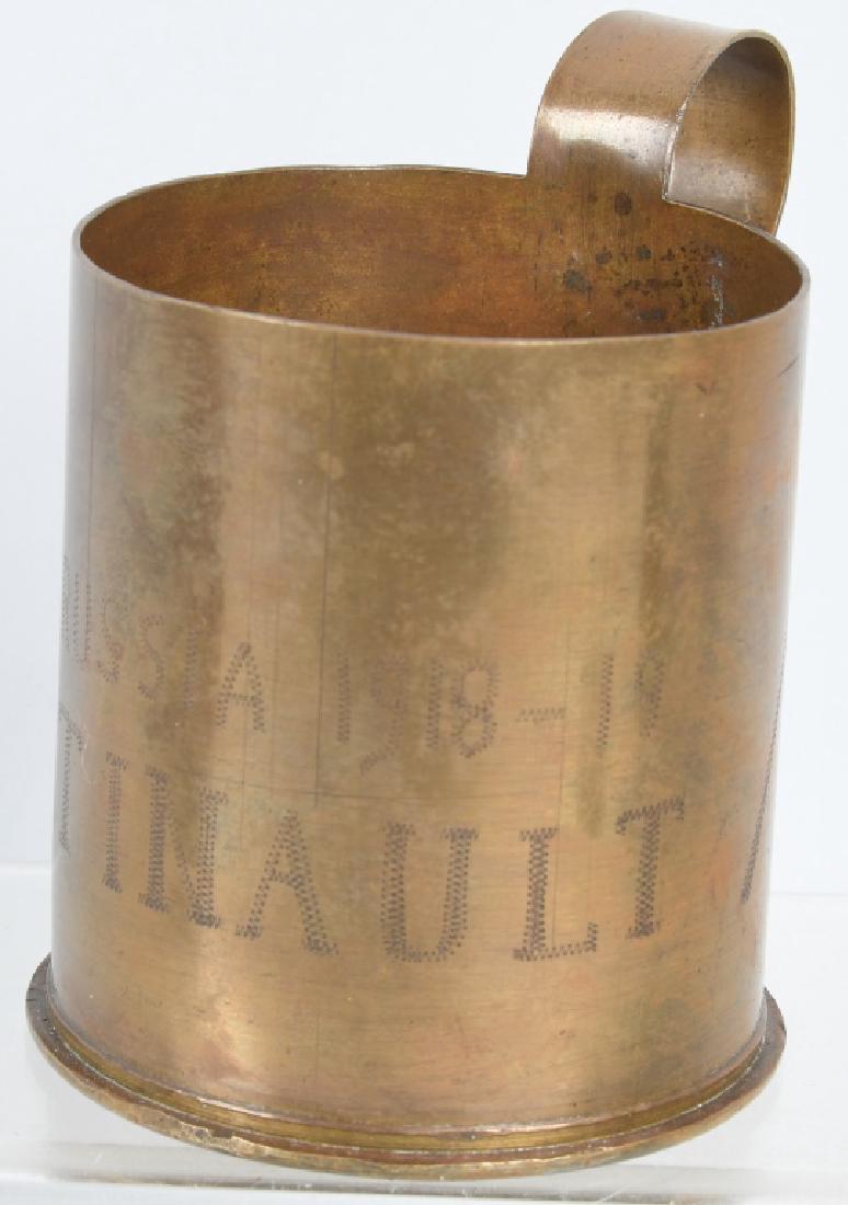 WWI U.S. ARMY 339TH INF. NORTH RUSSIA TRENCH ART: World War One trench art cup crafted from the base of an artillery shell and engraved, "North Russia 1918 -19 J.A.B. Tinault" and flanked by two flags. Albert Tinault is listed in the Bentley Library 