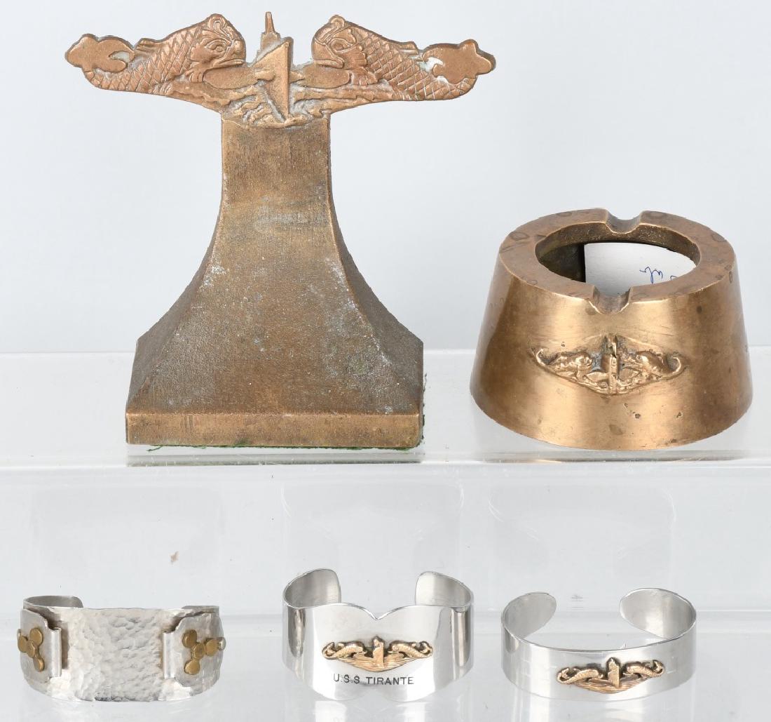 WWII U.S. NAVY SUBMARINE TRENCH ART GROUP: 5 pieces of submariner sailor trench art including a paper weight, ash tray, and three bracelets including one stamped to the U.S.S. Tirante. 4 of the 5 pieces include the submariner dolphin head insi