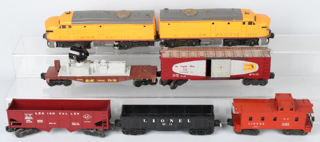 LIONEL #2023 UNION PACIFIC AA UNIT & 5 FREIGHTS: Lionel #2023 Union Pacific AA Unit, #6032 Gondola, #25000 Gondola, #64643 Box Car, #9302 Searchlight Car, and #6357 Caboose. Very Good