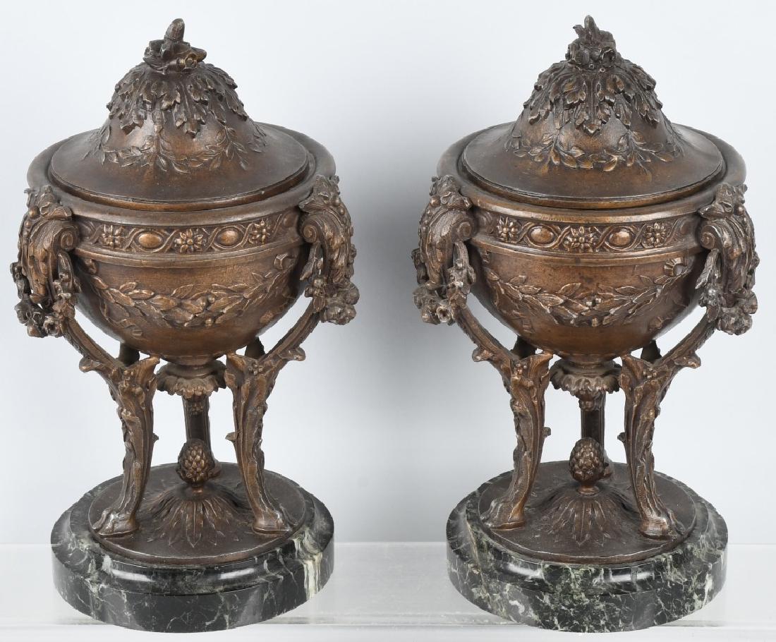 PAIR of ANTIQUE ORNATE CAST METAL URNS: Fantastic pair of cast spelter urns with marble bases. Very detailed with cast floral patterns and deer hoof feet. Excellent black marble bases. Each has a removable metal insert. 12" by 6 1/2", excel