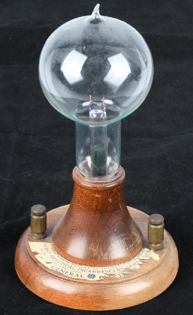1939 NY WORLD'S FAIR EDISON LIGHT BULB, SOUVENIR: Approximate replica of Thomas A. Edison's Incandescent Lamp from 1879. This was produced as a souvenir for the 1939 NY World's Fair. Some chipping to label. Very Good-Excellent