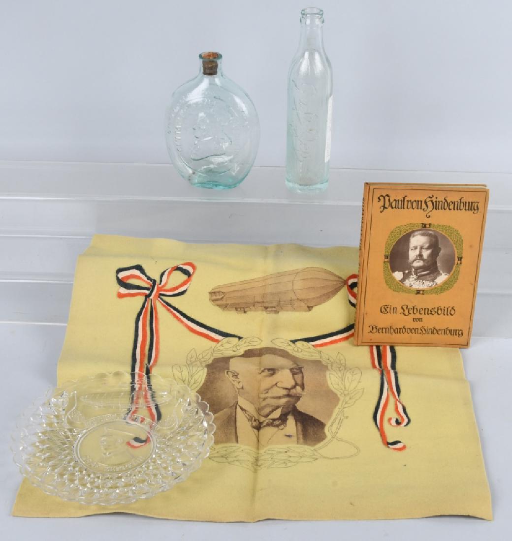 HINDENBURG GRAFF ZEPPELIN LOT & MORE: Very nice lot includes pressed glass plate of Hindenburg and Graf Zeppelin, a 18" by 18" felt of Hinderburg and a Zeppelin, a 1915 book on Hindenburg in German, a Graf Zep soda bottle, and a Washingto