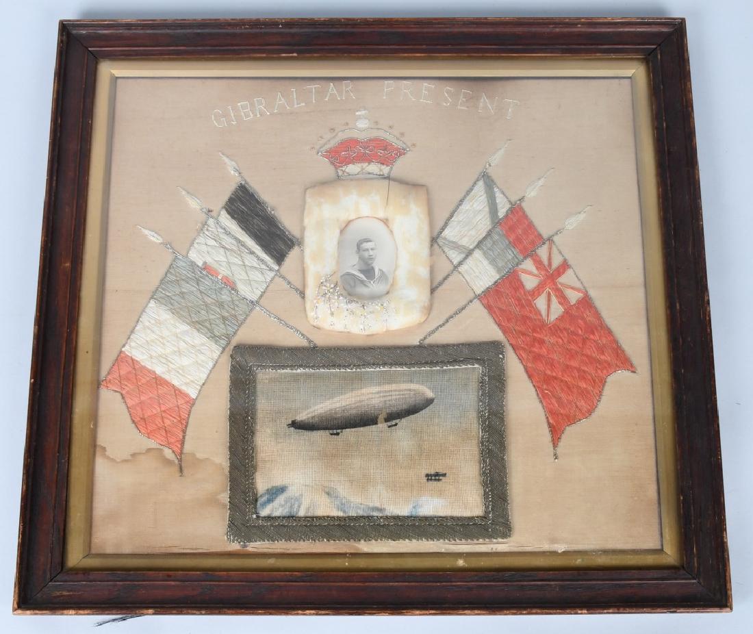 BRITISH SILK MEMORIAL GIBRALTAR AIRSHIP ZEPPELIN: Framed memorial featuring a photograph of a British sailor flanked by embroidered flags and above a stitched image of an airship. Stitched above the British crown is "Gibraltar Present" perhaps memori