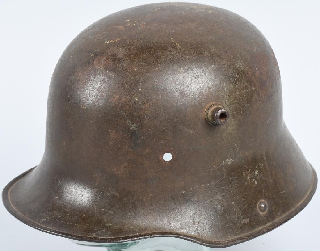 IMPERIAL GERMAN WWI M-16 / M-17 COMBAT HELMET: Imperial German WWI M-16 / M-17 Combat Helmet Shell. The trench helmet is painted with an OD green paint. The inside skirt is maker and size marked bell 'L 64''. Neat for display.