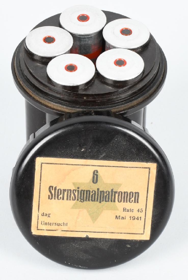 WWII NAZI GERMAN BAKELITE FLARE CASE W ITH FLARES: German bakelite flare container still retains its original paper label, "6 Sternsignalpatronen" and is dated May 1941. Still contains 5 flares; two are green and three red. excellent.