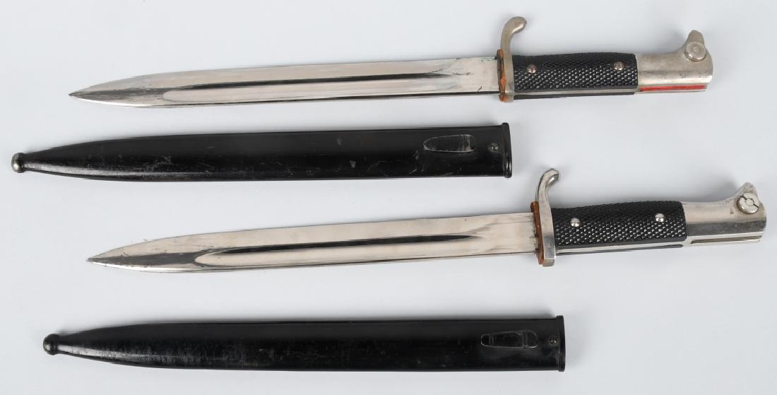 WWII NAZI GERMAN K98 DRESS BAYONETS: Two German k98 dress bayonets with scabbards both in excellent condition. The first is an Eickhorn and still retains the company designation insert in the lug slot. The second is an Alcoso, Solingen. 