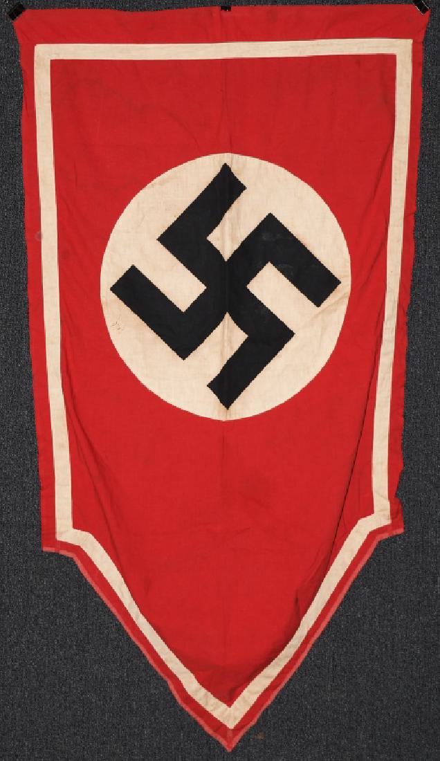 WWII NAZI GERMAN PODIUM BANNER - SHIELD SHAPED: Double sided podium banner with a printed swastika on applied disc. Machine stitched white trim. 31" x 56". Minor fraying in one corner. very good - excellent.