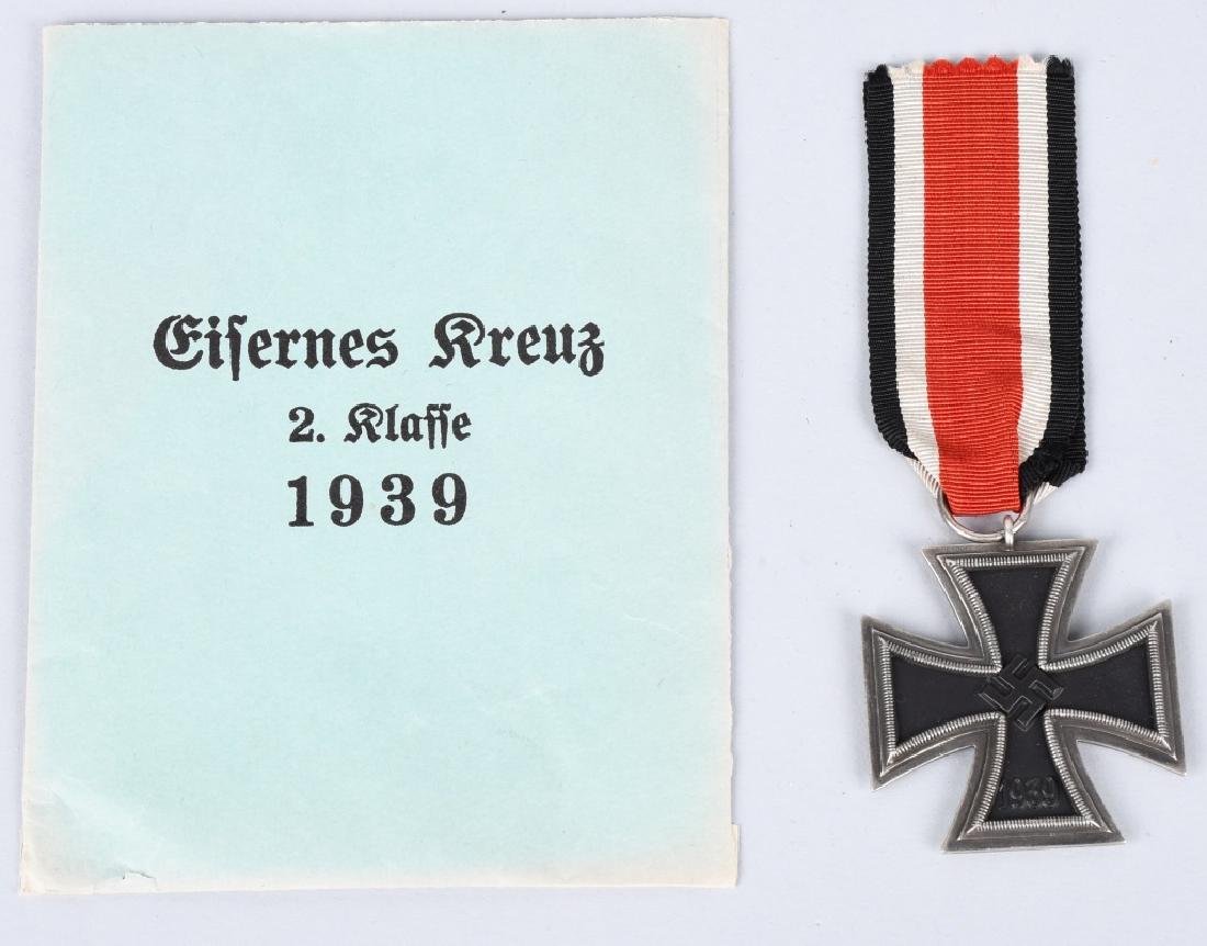 WWII NAZI GERMAN 2ND CLASS IRON CROSS W/ ENVELOPE: German WWII 2nd Class Iron Cross with Envelope. The suspension ring is maker marked '107'. Three piece construction with an iron magnetic center. Includes the named presentation issue paper award enve