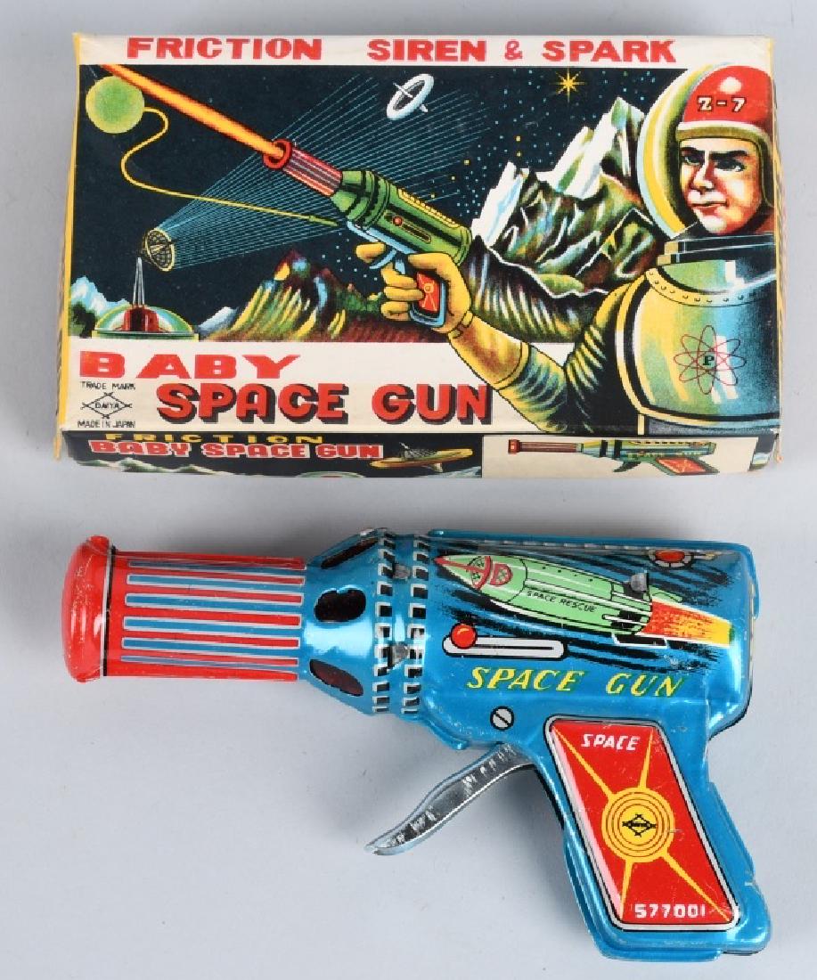 JAPAN Tin Friction BABY SPACE GUN w/ BOX: New Old Stock. Excellent rocket graphics on the gun. Box has great spaceman graphics. 6" Near Mint